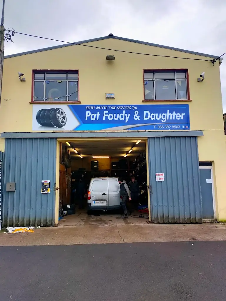 Pat Foudy and Daughter tyre centre on Pound Lane, Ennis, with the blue shop sign and a van in the tyre bay